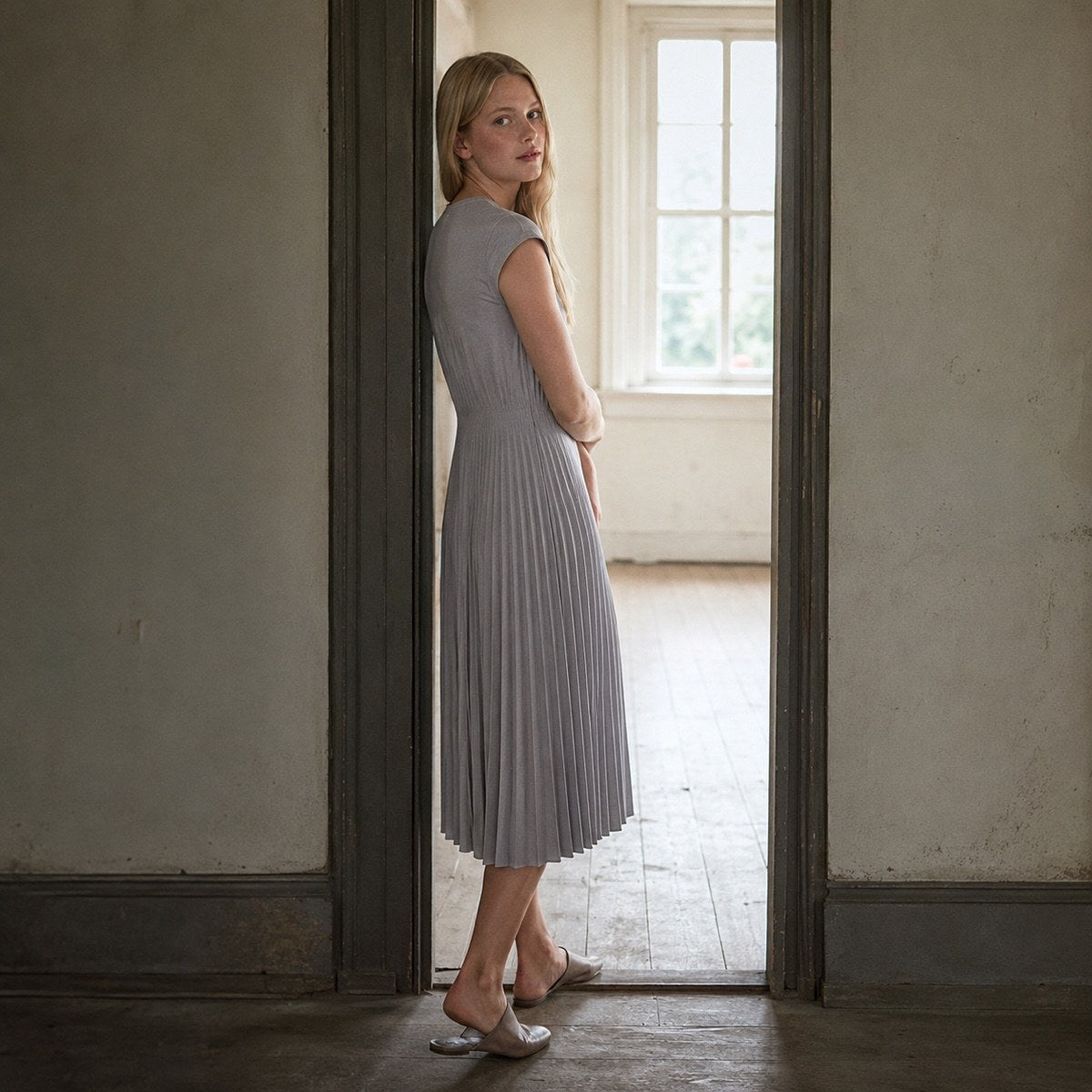shown worn, from the side — Chislehurst sunray-pleat midi dress, Pleated Midi Dresses by ORASCI.